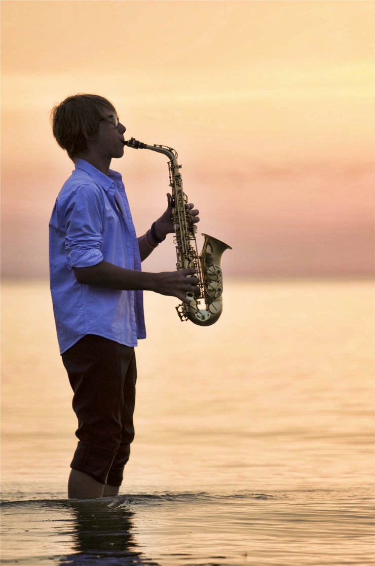 Musician music saxophone play playing song songs instruments instrument sea water ocean sky sunset