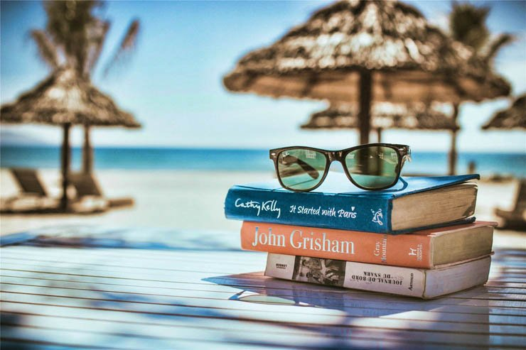 Summer beach umbrella table wood sunny book books sunglasses