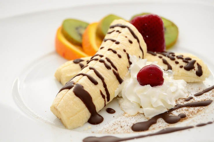 banana cake fruit cake cherry chocolate orange kiwi plate restaurant food meal eat sweet