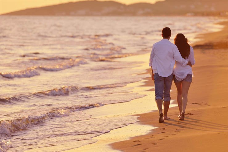 beach couple walk walking romantic sand water sea romance love man woman ocean wave waves