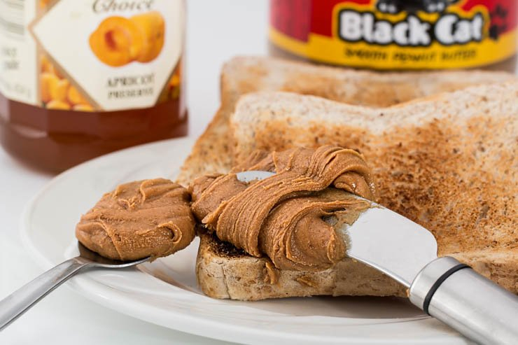 butter bread slice loaf breakfast knife spoon peanut nut food snacks