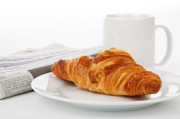 croissant breakfast tea coffee morning newspaper food plate mug cup