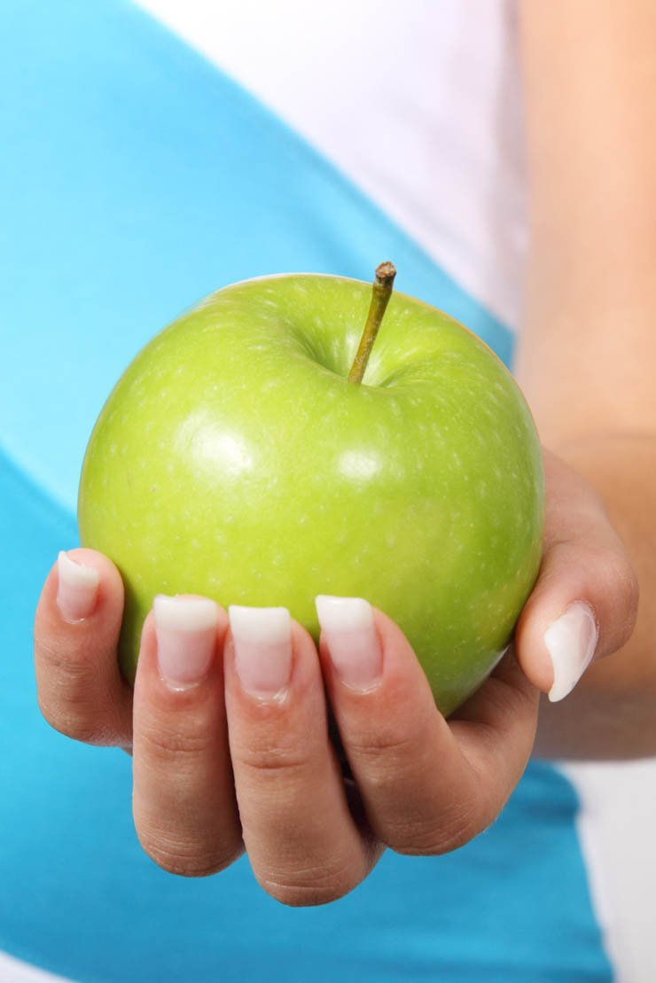 female holding green apple hand