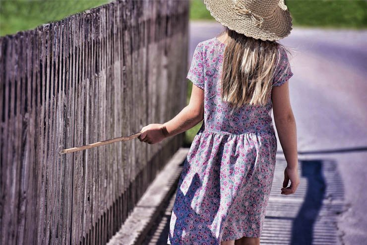 girl hat kid kids stick fence garden park stret walk walking play playing hat