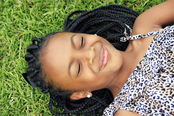 happy girl laying grass smile beautiful young african africa
