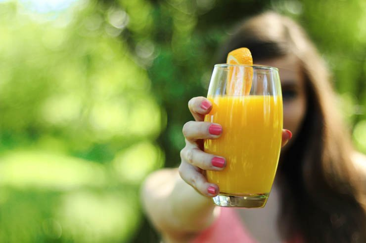 orange juice drink drinks glass outdoor nature girl hand hold