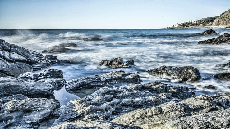 rock rocky beach stones ocean water sea