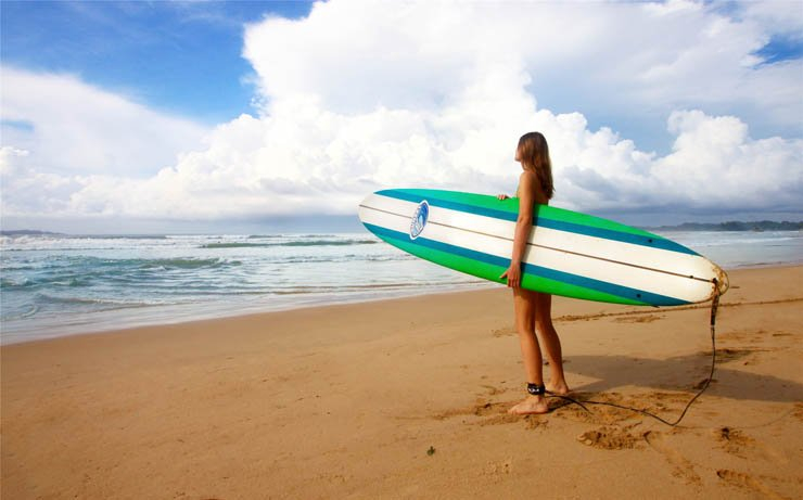 water sports sea sport ocean surfing surf wave waves board woman lady beach shore cloud sky athlete