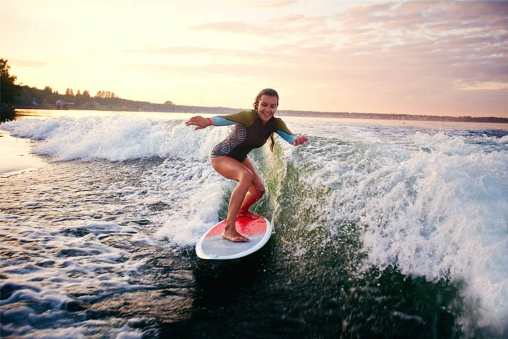 water sports sea sport ocean surfing surf wave waves board woman lady enjoy sunset swimmingsuit swimmingwear athlete