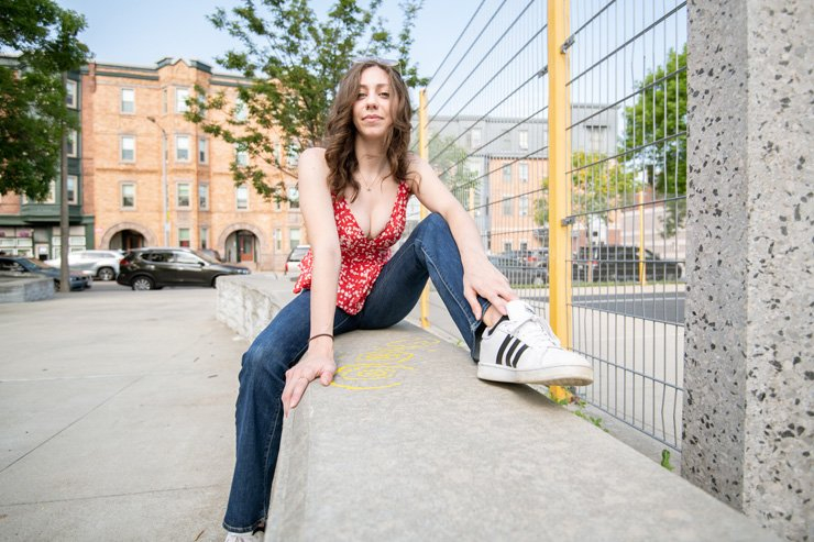 fashion beauty elegant elegance style stylish fashionista fashionable outfit wavy hair red blouse jeans shoes fence road building sit sitting lady woman women female