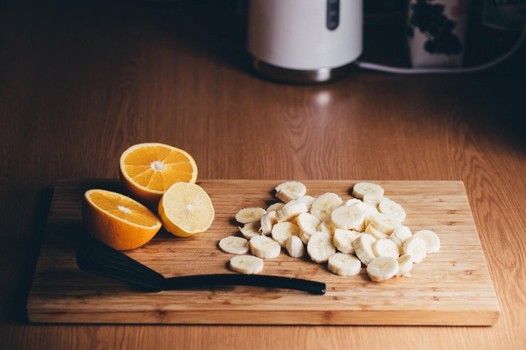 fruit fruits food healthy health diet banana orange lemon cutting board