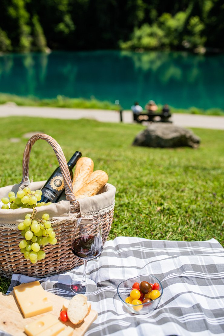lifestyle food summer wine picnic bread cheese mat rug grass lake grapes grape basket bucket outdoor
