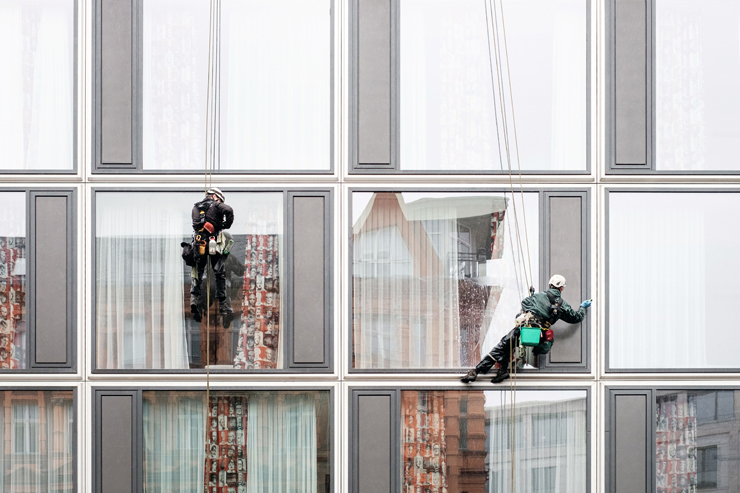 Men Cleaning Windows by Rapelling