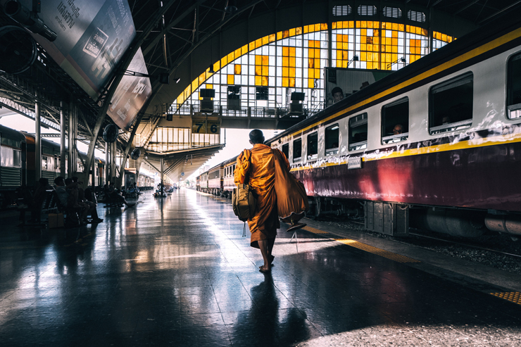 
									Monk Walking in Train Station