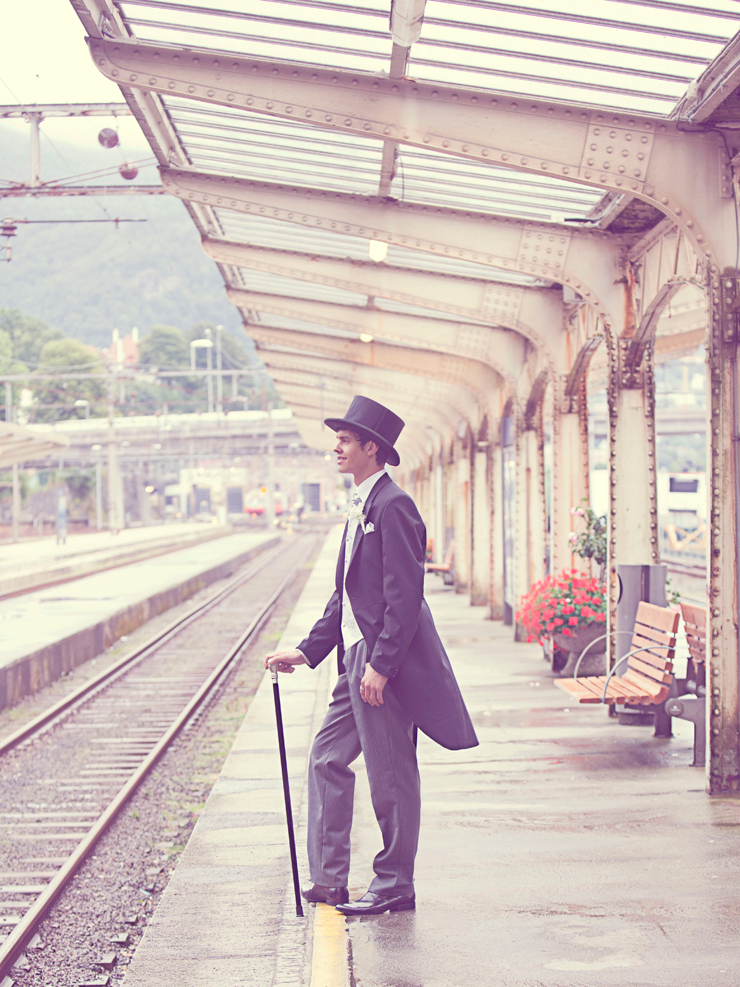 Sepia Effects Photo of Man in Black Tuxedo Standing on Train Station during Daytime