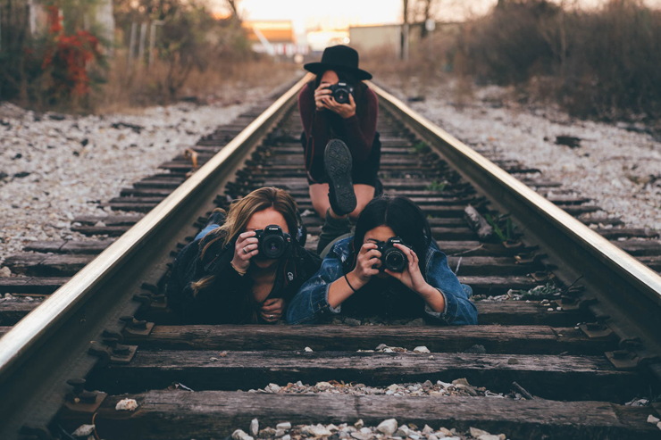 Three Girls on Train Tracks Taking Photo of Cameraman