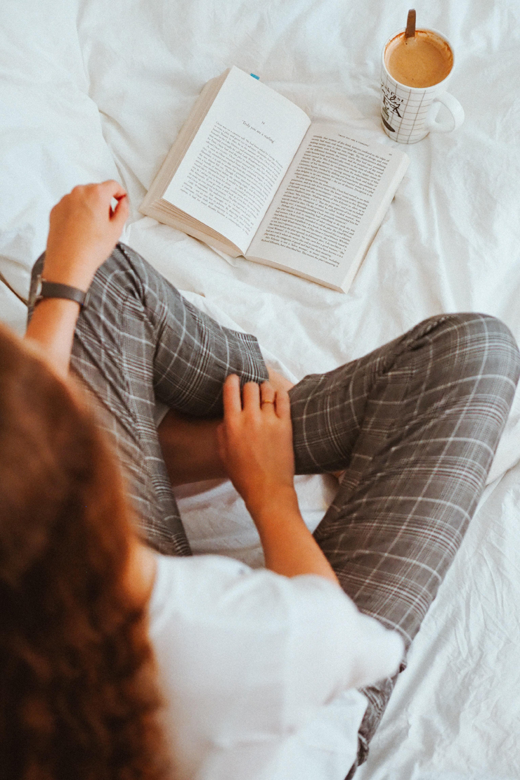 Girl Reading Book In Bed